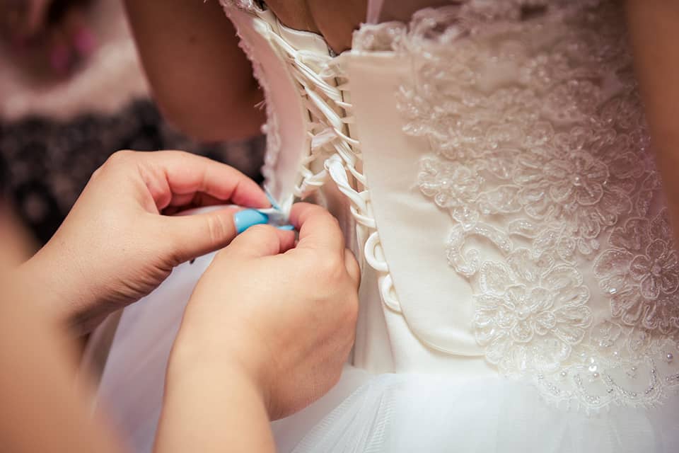 woman fixing the wedding gown