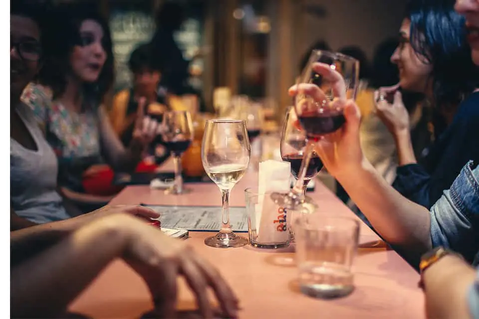 people-drinking-liquor-and-talking-on-dining-table-close-up
