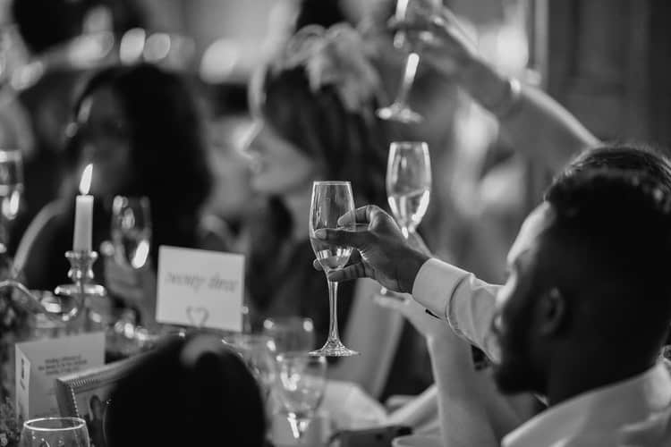 wedding guests raising glasses