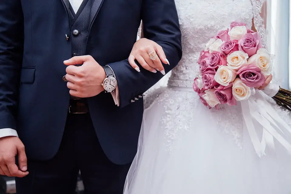 bride holding bouquet of flowers beside groom 