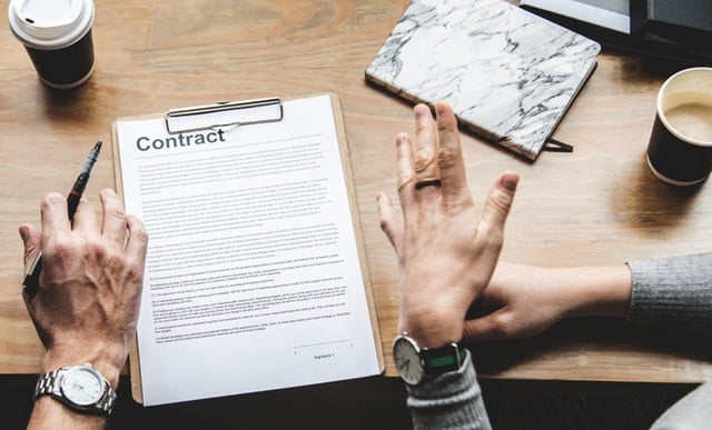 a couple reviewing the service contract to decide how much to tip wedding vendors 