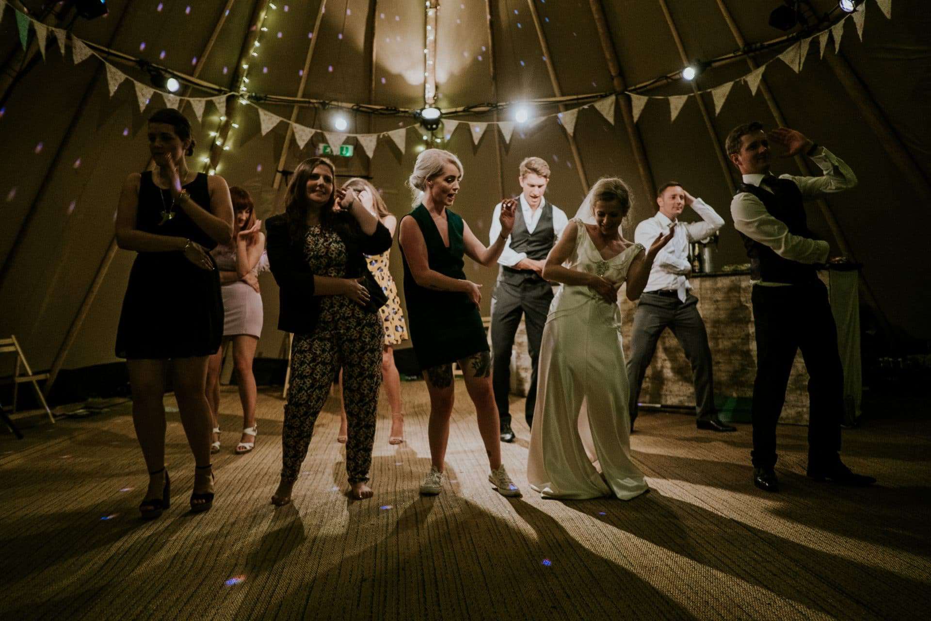 bride and groom and friends dancing