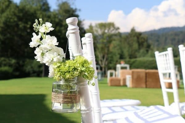 white chairs in a garden wedding