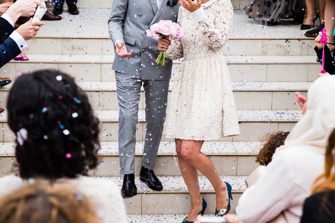 cropped image of a newly wed couple at wedding stairs