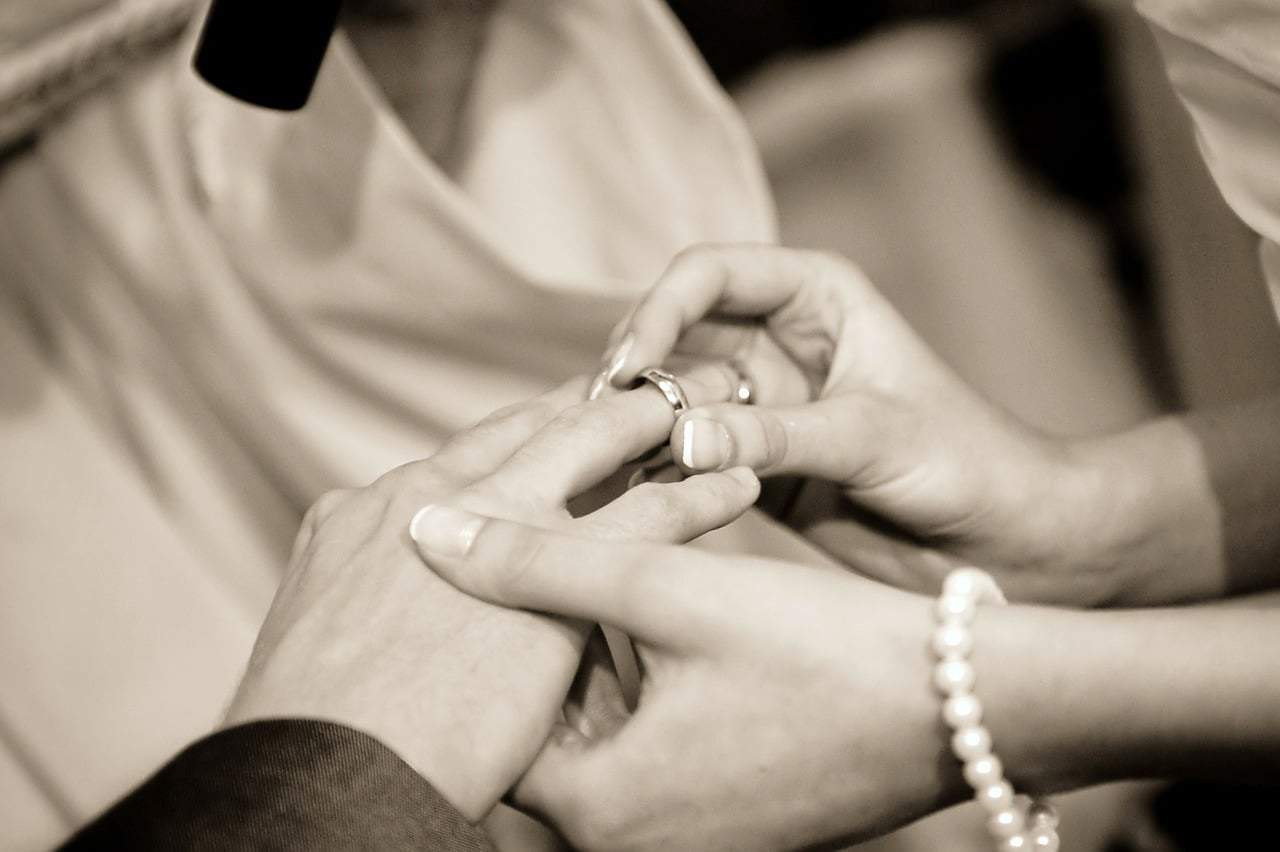 bride wearing the ring to the groom 